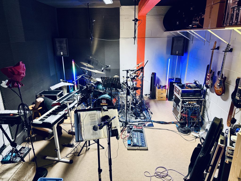 They Might Be Dogs rehearsal room with instruments and equipment, where the band develops its atmospheric progressive rock sound.